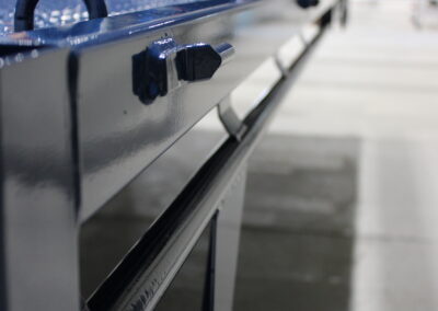 A freshly powder coated Ox Trailer tray, hanging in the powder coating bay.