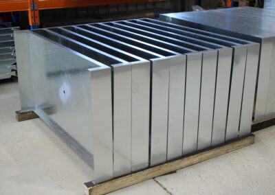A pallet of laser cut and folded steel sheet.