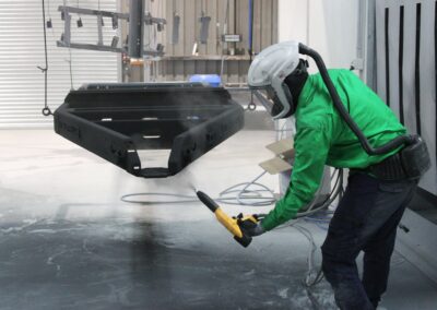The Head of Bromarc Powder Coating applying primer to the chassis of an Ox Trailer.