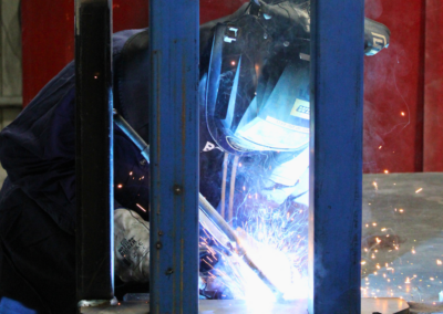 A Bromarc Employee welding in the Australian workshop